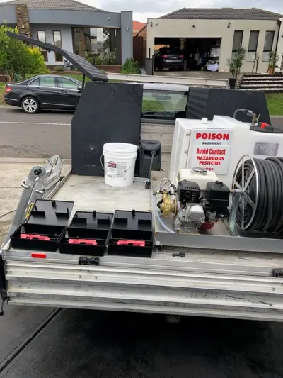 Babylon Pest Control service trailer with spray rig, bait stations and equipment