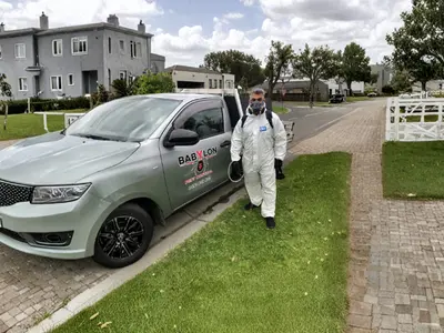 Technician walking a residential driveway beside the branded ute